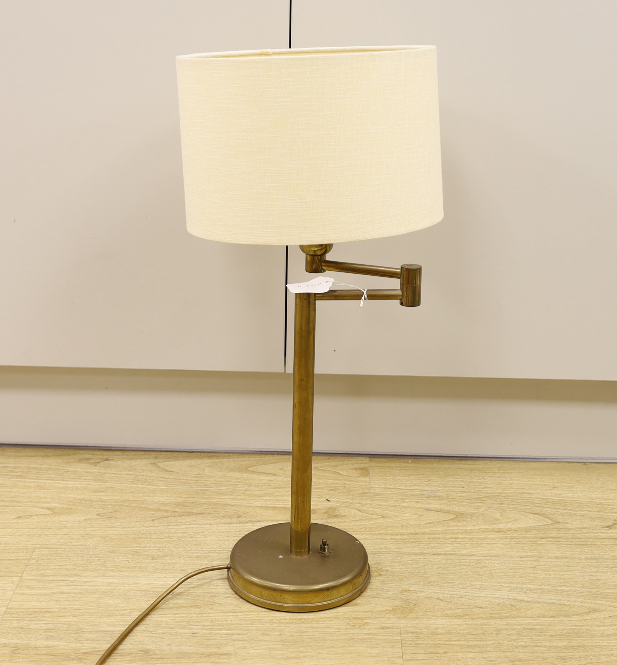 A brass swivel arm table lamp